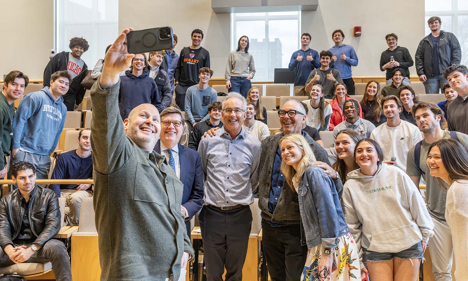 During “Leadership and Strategy in Entrepreneurial Organizations,” author and former COO of Meta Sheryl Sandberg, James Beard award-winning chef Dan Kluger and venture capitalist Katie Stanton joined class. Here, Kluger takes a selfie with President Mark D. Gearan, Professor of Business Management and Entrepreneurship Tom Drennen, CEO of Chegg Dan Rosensweig ‘83, Stanton and students.  