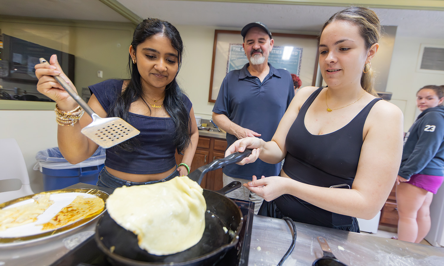 During “Eat Like a Slav,” Associate Professor of Russian Area Studies David Galloway teaches students how to make “blin,” a traditional Russian pancake, in the Jackson-Potter-Reese Kitchen. 
