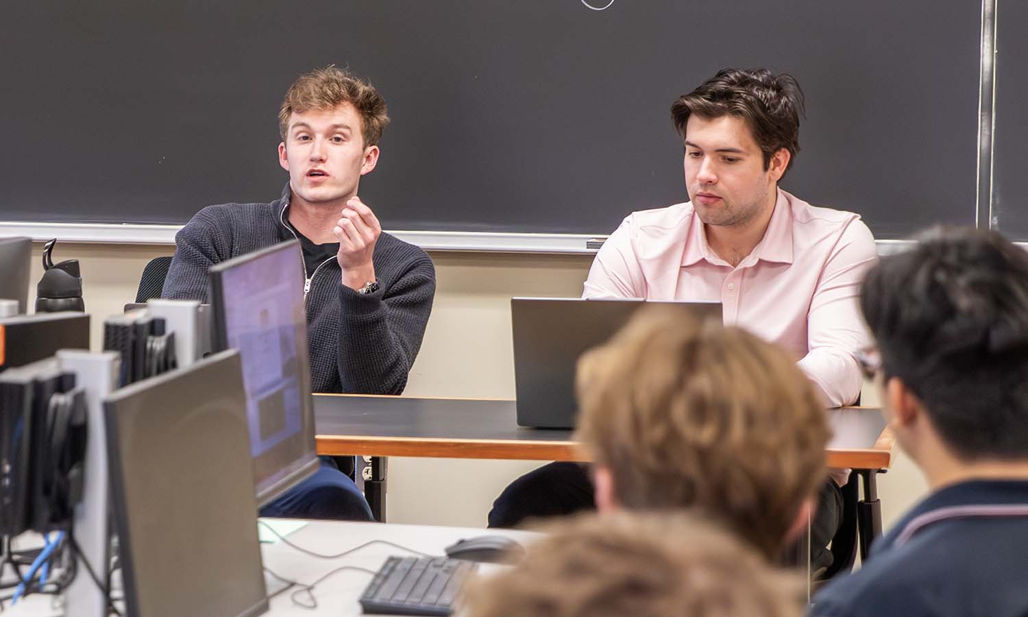 Easton Ryan ’27 and Mason Fairfield ‘26 lead a meeting for the Investment Club. 