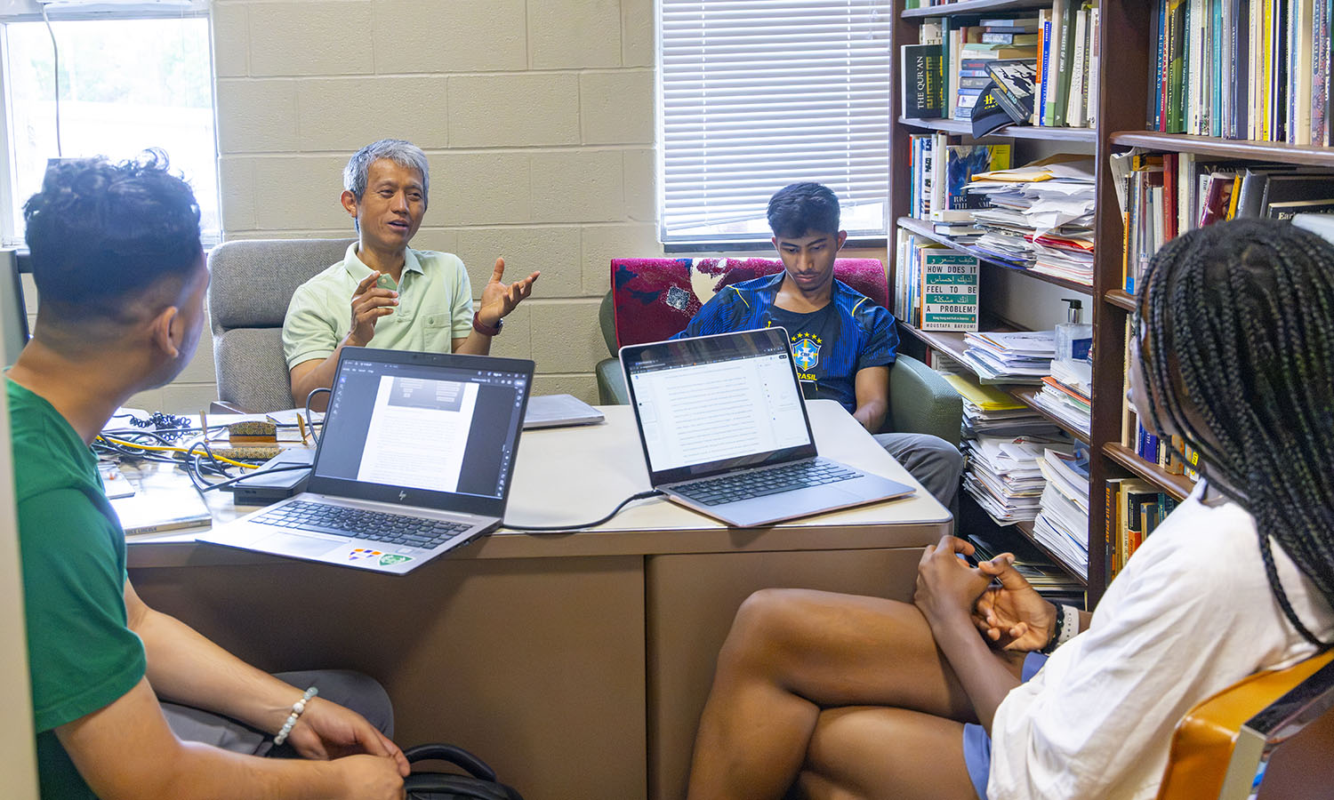 Associate Professor of Religious Studies Shalahudin Kafrawi meets with summer research students Jubayer Ansary ’29, Hasibul Islam Shadin ’29 and Danielle Dezart ’28 to discuss how religious beliefs and practices influence entrepreneurship and shape approaches to business and economic life. 