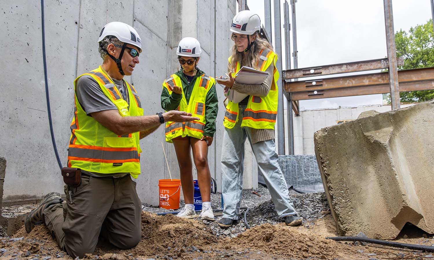 Associate Professor of Geoscience David Finkelstein shows sediment from an unusual layer of sand discovered beneath the future Fish Center for the Sciences to Communications Intern Kieran Yadav and Senior Writer Mary Stone. The unexpected find will support student research into the glacial past of the Finger Lakes.  