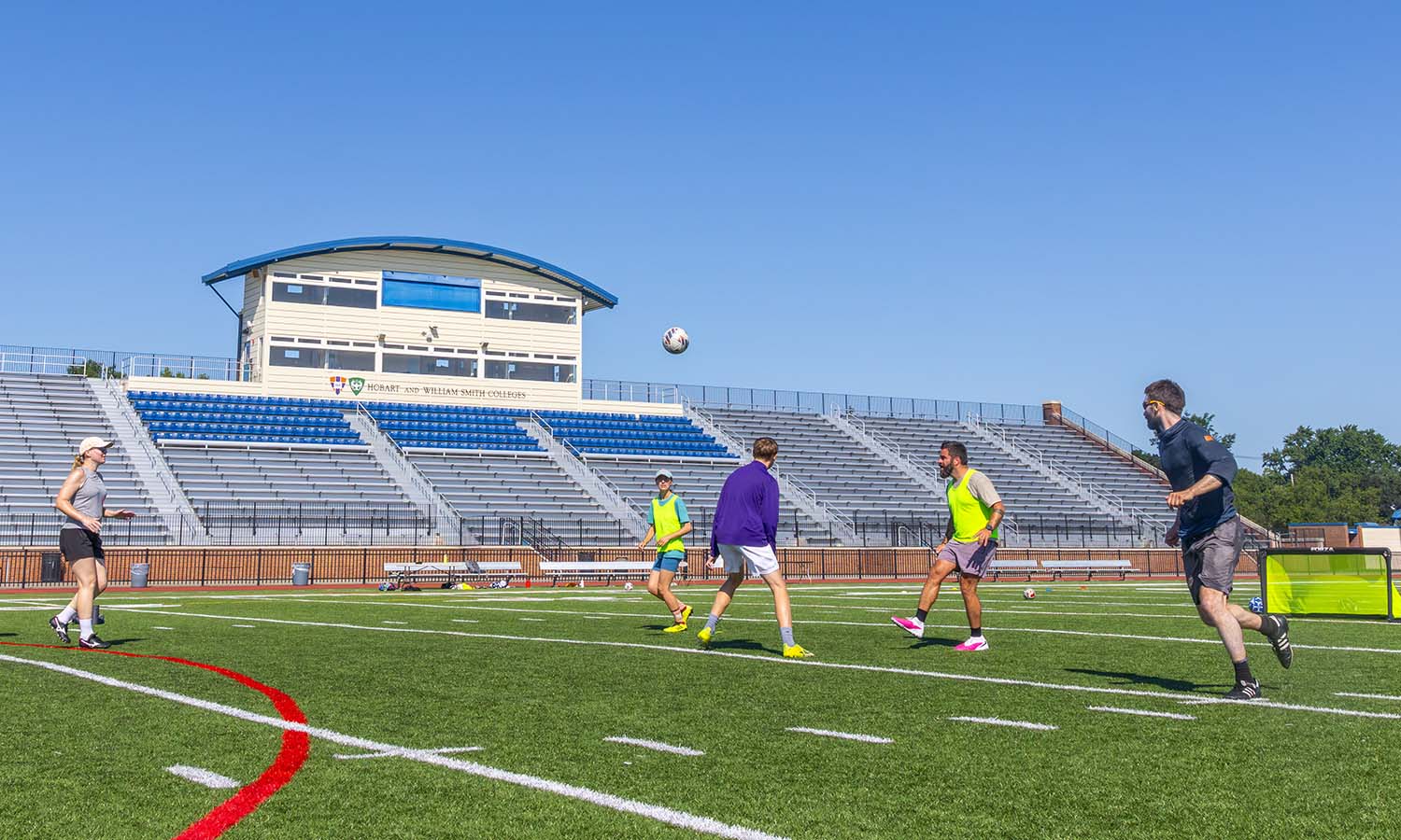 Faculty, staff and community members play pickup soccer on Boswell Field. 