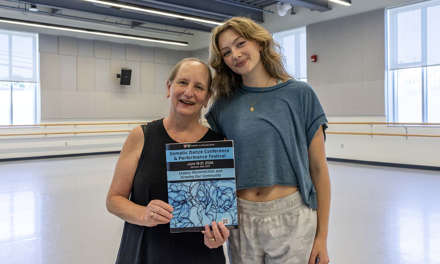 Professor of Dance and Movement Studies Cynthia Williams and Campbell McCormick ‘28 pose with the program for the Somatic Dance Conference & Performance Festival they coordinated and hosted in the Gearan Center for the Performing Arts this summer. 