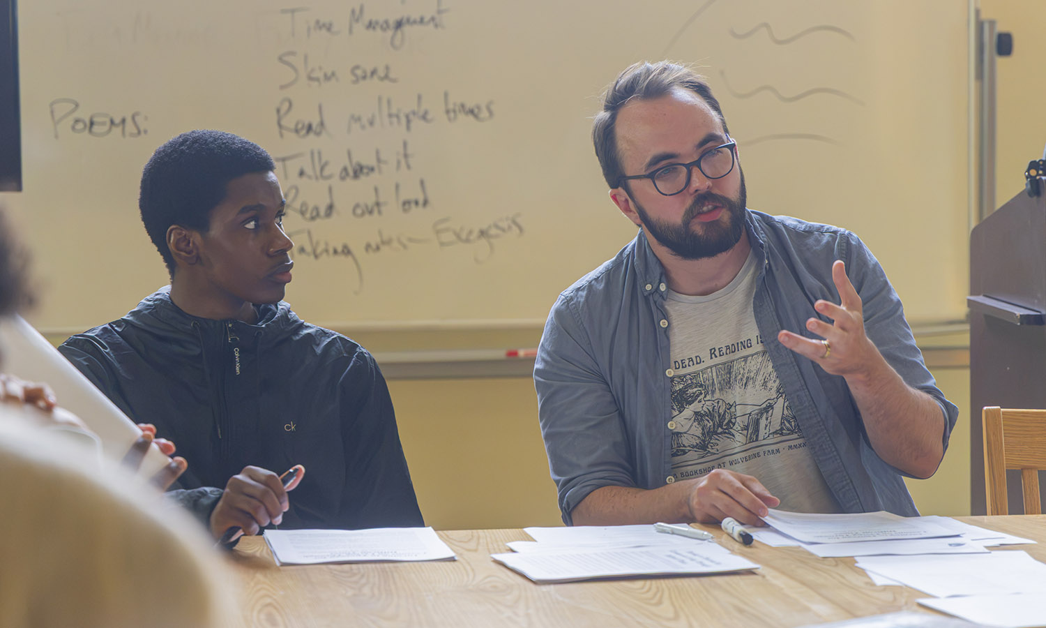 Professor of Practice and Director of HWS Debate Daniel Schonning '16 discusses the upcoming semester with students in his First Year Seminar "Speak, Memory: Writing from Life." 