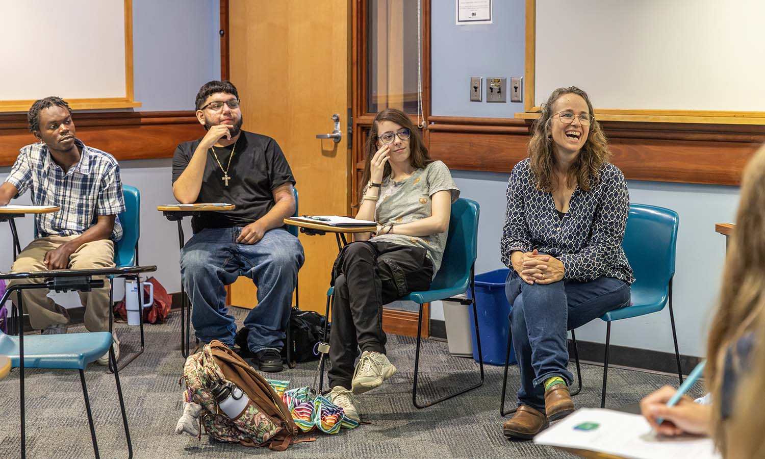 Professor of Spanish, Latin American, and Bilingual Studies May Farnsworth shares a laugh with students during the first class session of "Bilingual Realities." 