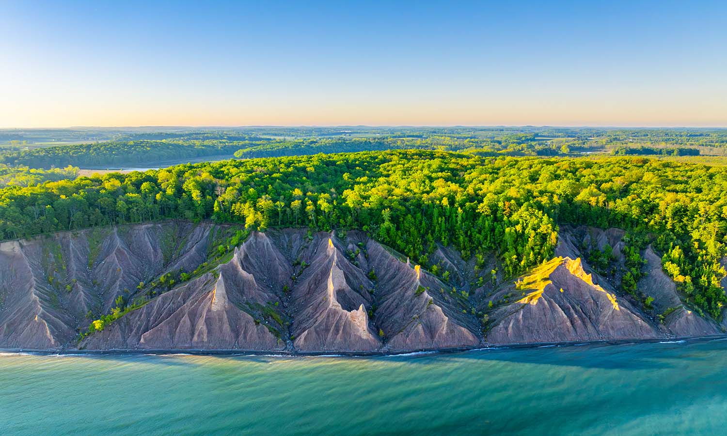 An aerial view of the Chimney Bluffs along Lake Ontario on a sunny morning in May.  