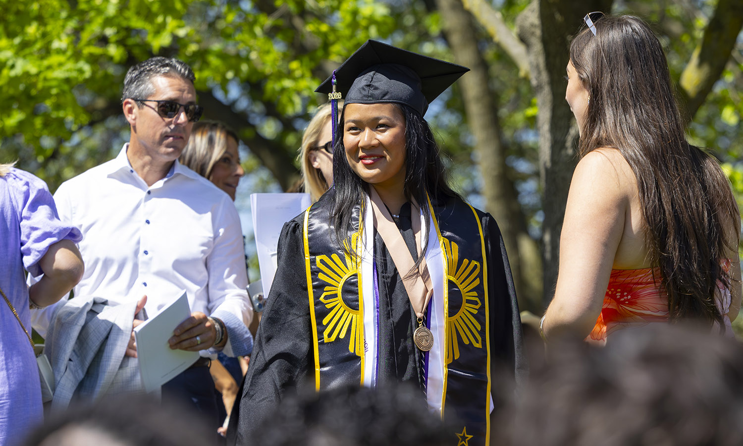 Loreine Mungcal '26 looks out at the crowd of students and visitors gathered for commencement. 