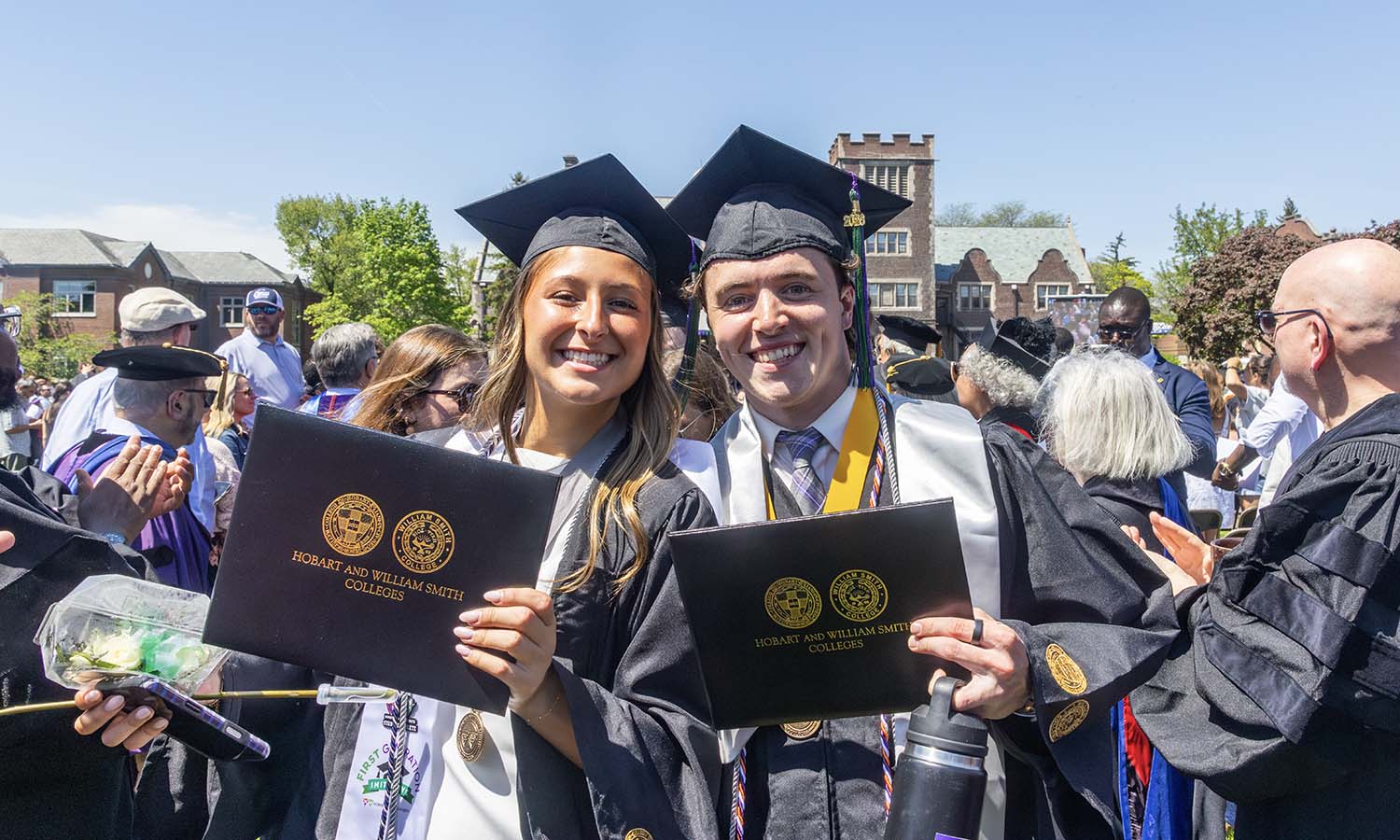 Malya Sayre '26 and Kahlil Fontana '26 pose for a photo after receiving their diplomas. 