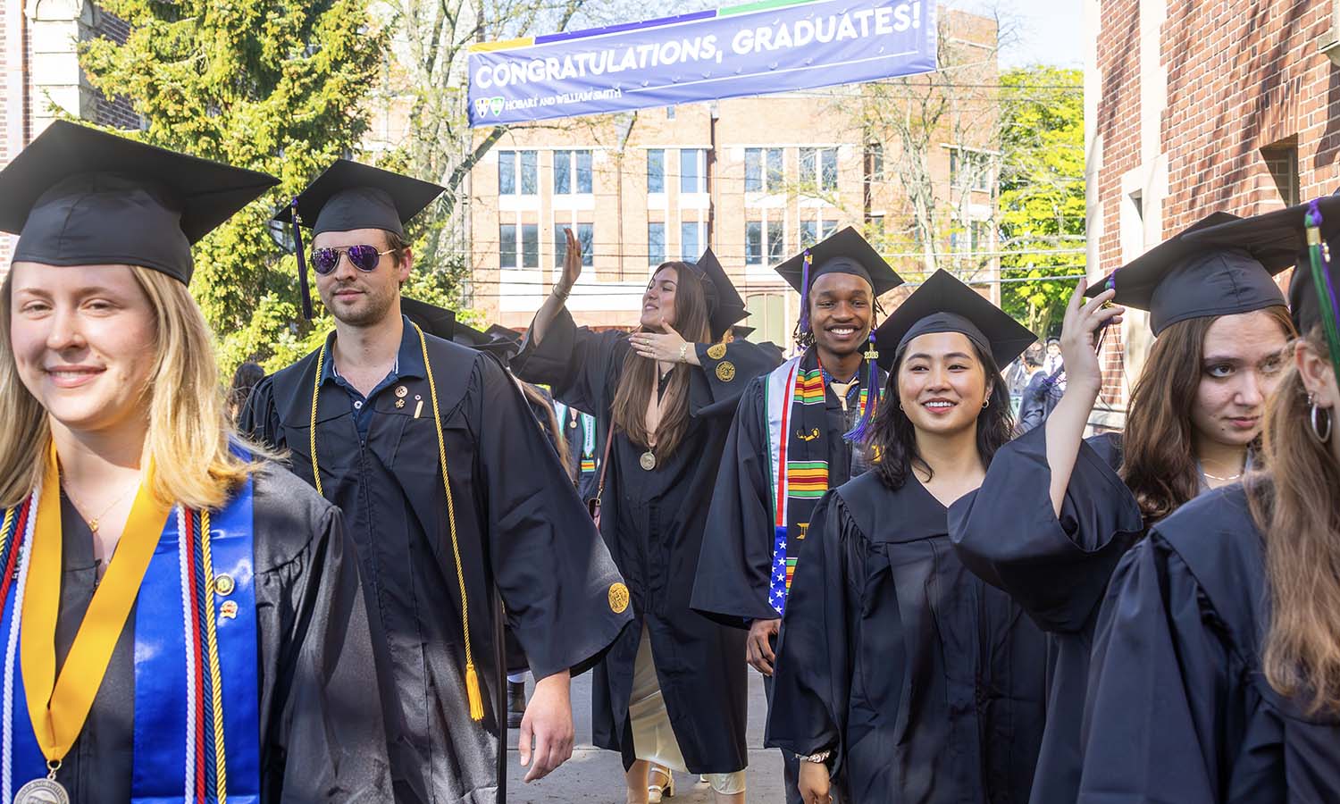 Students process by Williams Hall. 