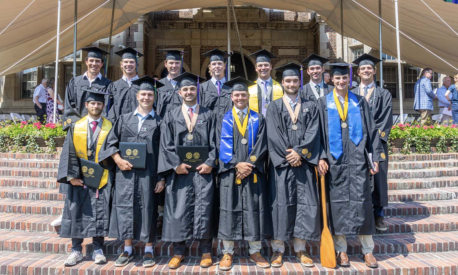 Hobart baseball seniors gather for a photo on the steps of Coxe Hall. The team was competing in the NCAA Division III Tournament and unable to attend the official Commencement exercises, so their achievements were celebrated a day later. 