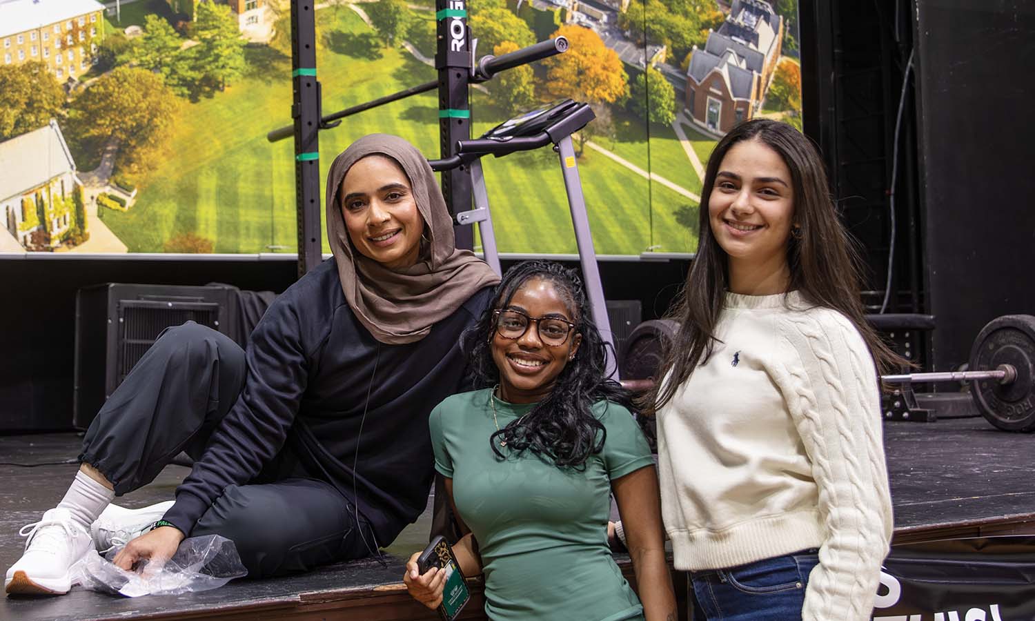 After sharing her path to becoming an Under Armor global ambassador and mountain climber, Saman Munir poses for a photo with Mary Gyamerah ’28 and Lina Hassini ’26 during the event hosted by the Muslim Student Association and Muslim Life Center. 
