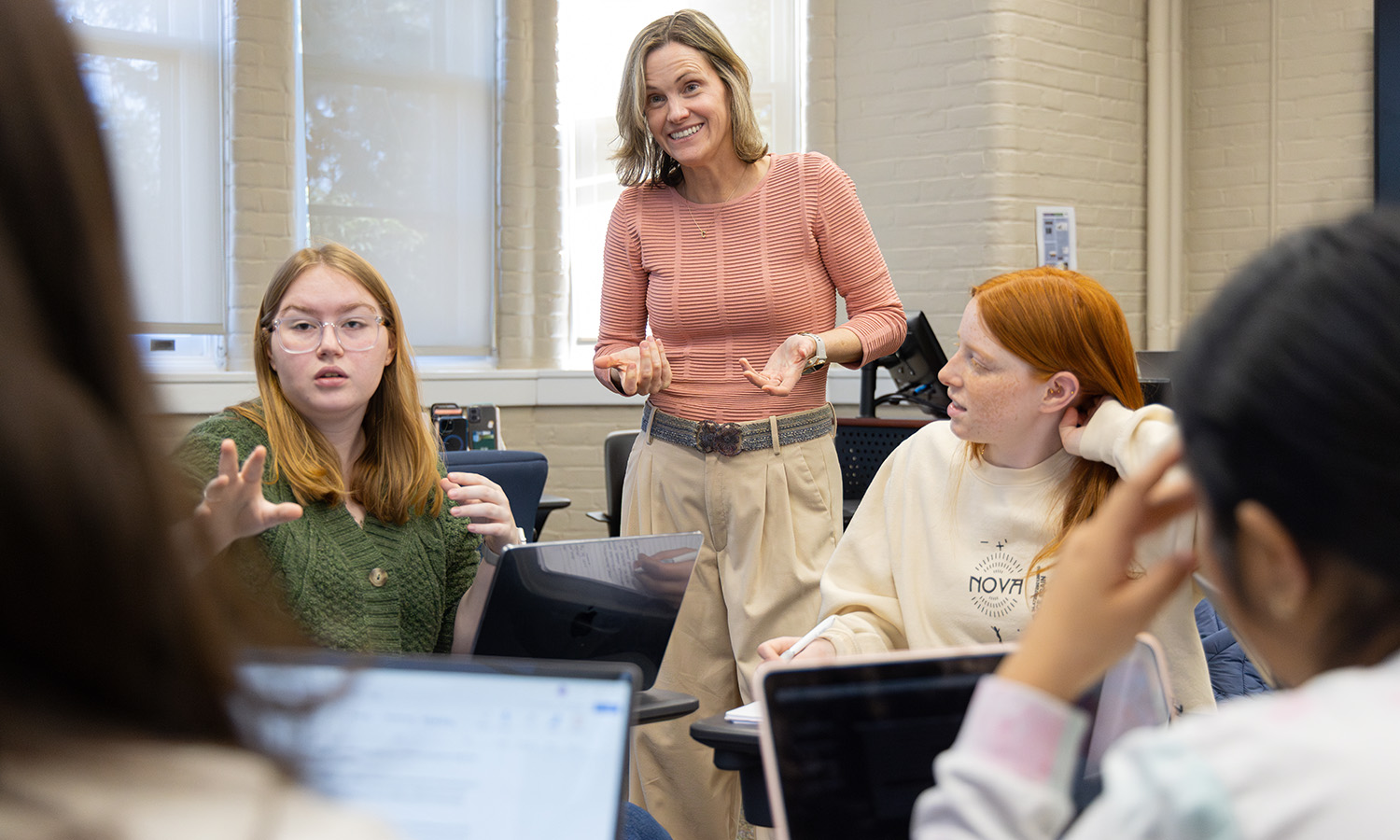 Professor of Spanish and Hispanic Studies Carolina Travalia helps students prepare for a mock debate in "Spanish for Conversation and Debate." 