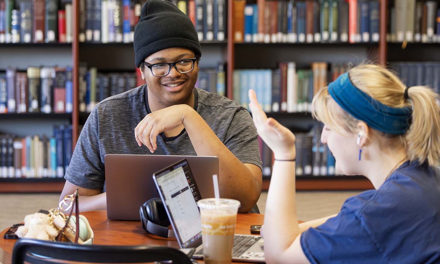 Students share a laugh while studying in the Warren Hunting Smith Library. 