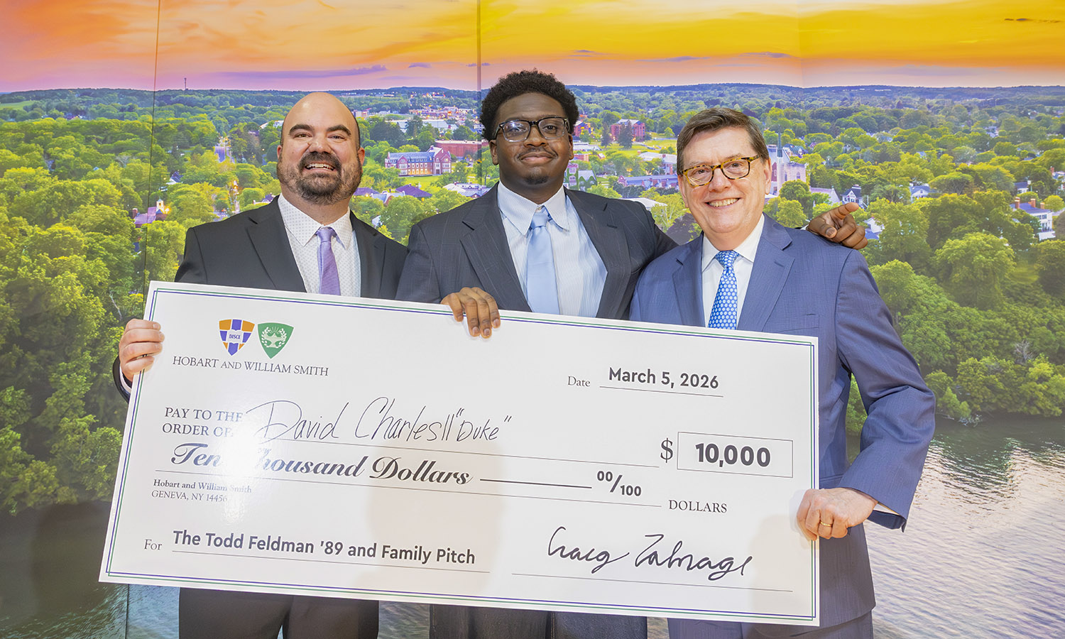 Director of the Bozzuto Center for Entrepreneurship Craig Talmage and President Mark D. Gearan pose with the Pitch Contest winner David Charles II, “Duke” ’27. 