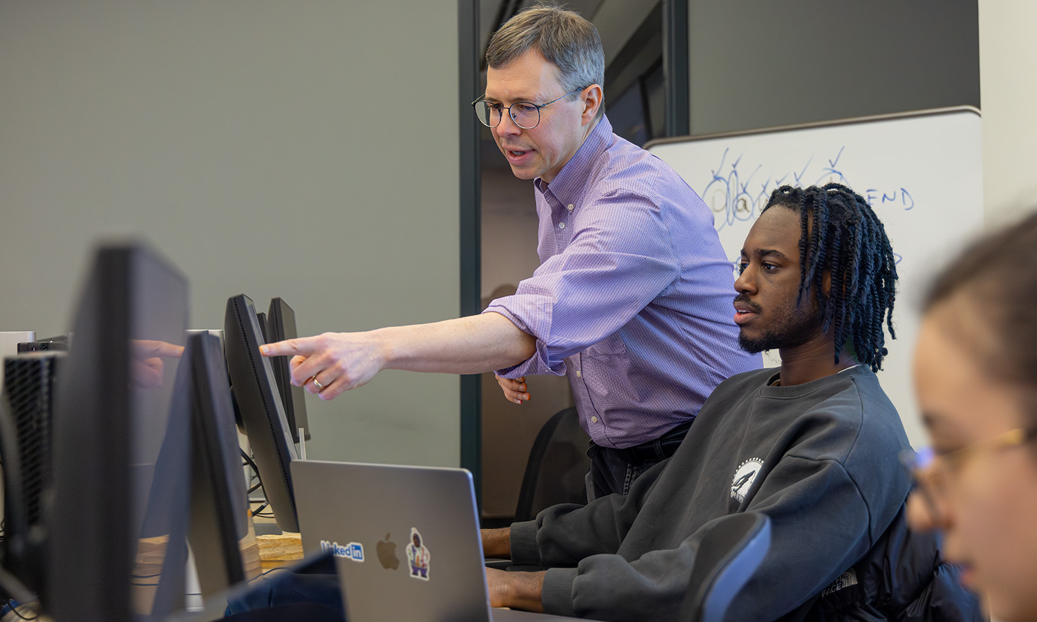 Associate Professor of Mathematics and Computer Science Chris Fietkiewicz helps Mark Dosu ‘27 during a lab for “Compilers” in Demarest Hall. 
