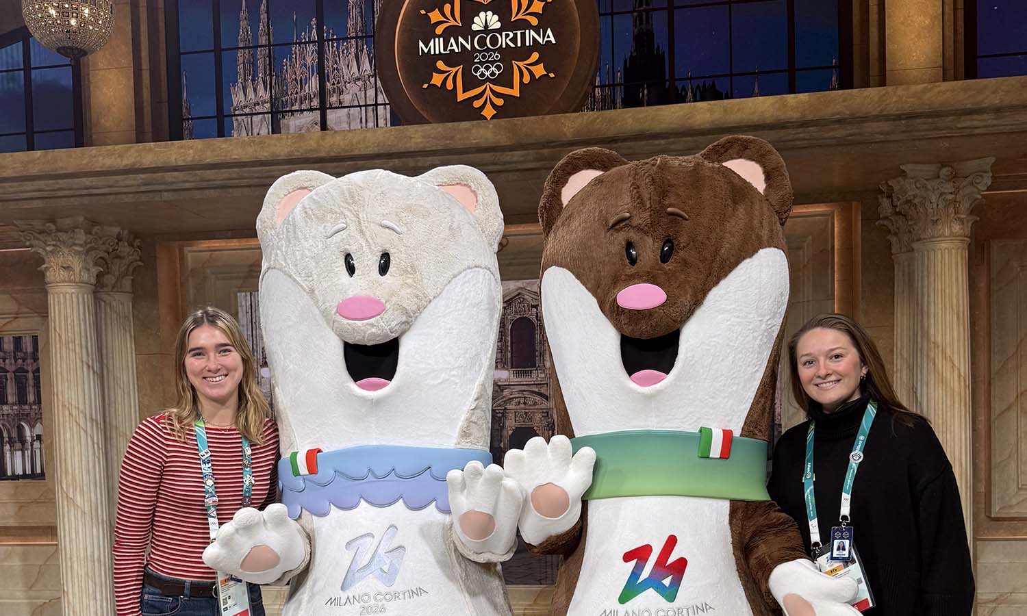 Mia Tetrault ’25 and Margo Grapshi ’22 pose for a photo with the mascots of Milan Cortina 2026. Both are in Italy working for NBC to provide coverage of the Olympic Winter Games. 