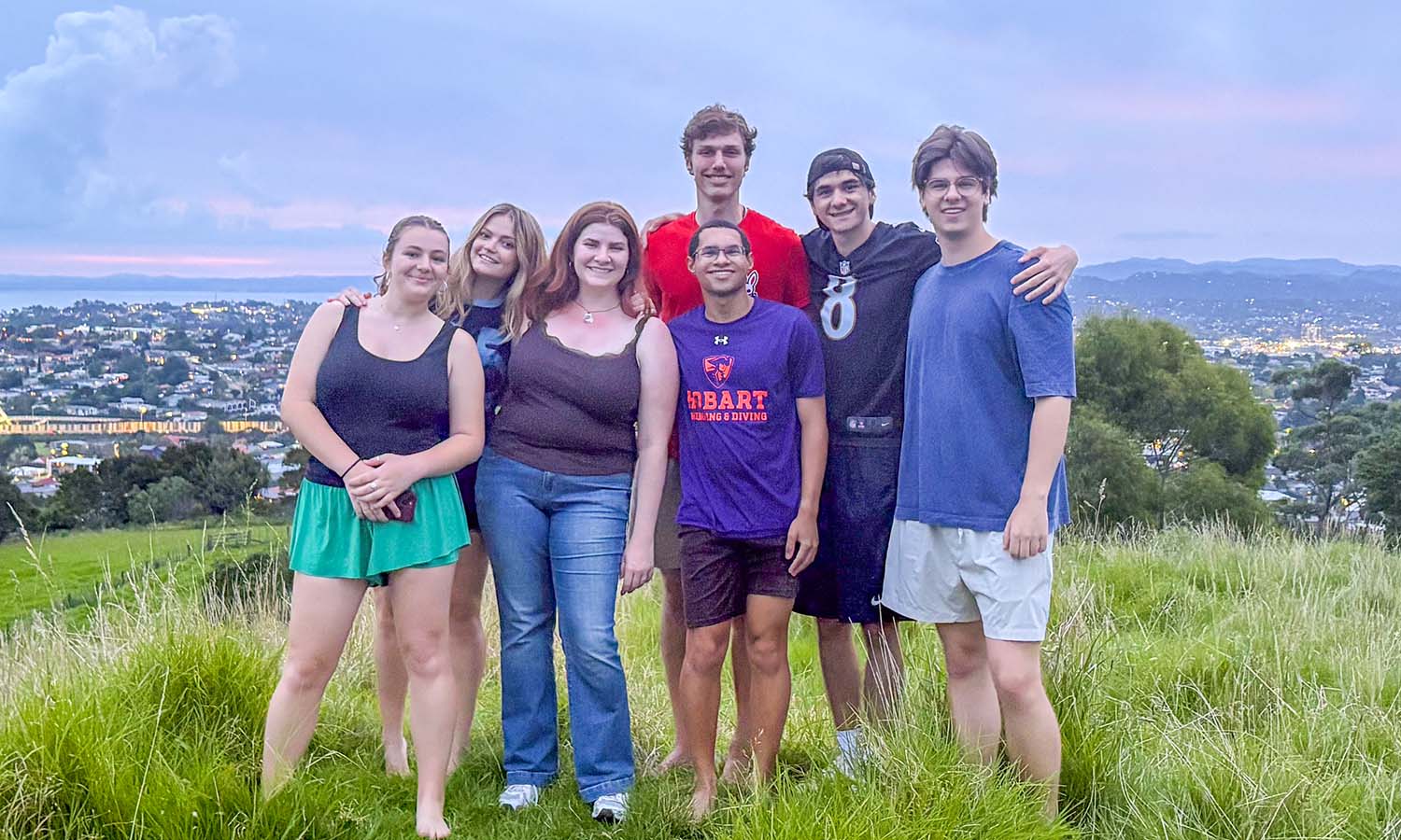 Students studying abroad in Auckland, New Zealand with Associate Professor of Economics Keoka Grayson pose for a photo at Mount Albert Park. 