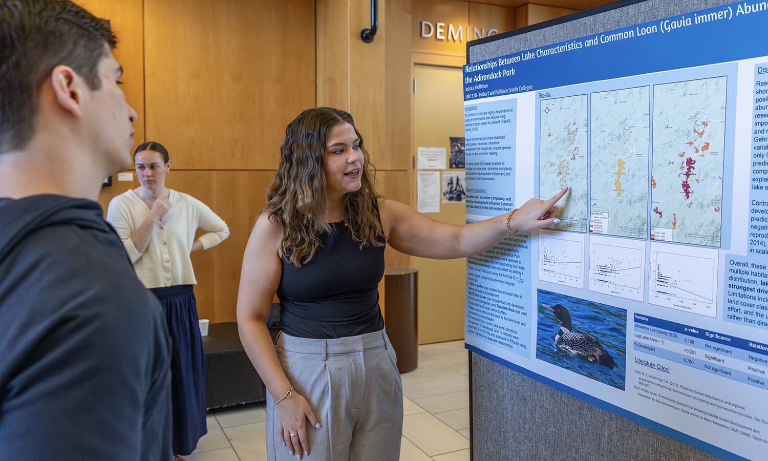 At the Advanced GIS poster session in the Melly Lobby of the Gearan Center, Jessica Hoffman '27 presents her research about the factors effecting the Common Loon population on lakes in the Adirondack Mountains. 