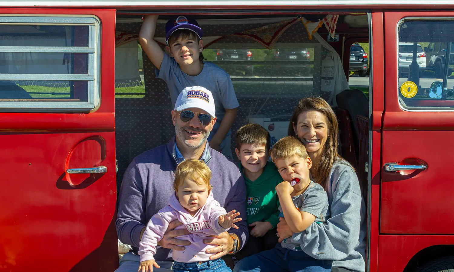 Vice President and General Counsel Lou Guard '07 and his wife, Trustee Kirra Guard '08 MAT '09, pose with their children at the Gameday Lunch and Fun Fest. 