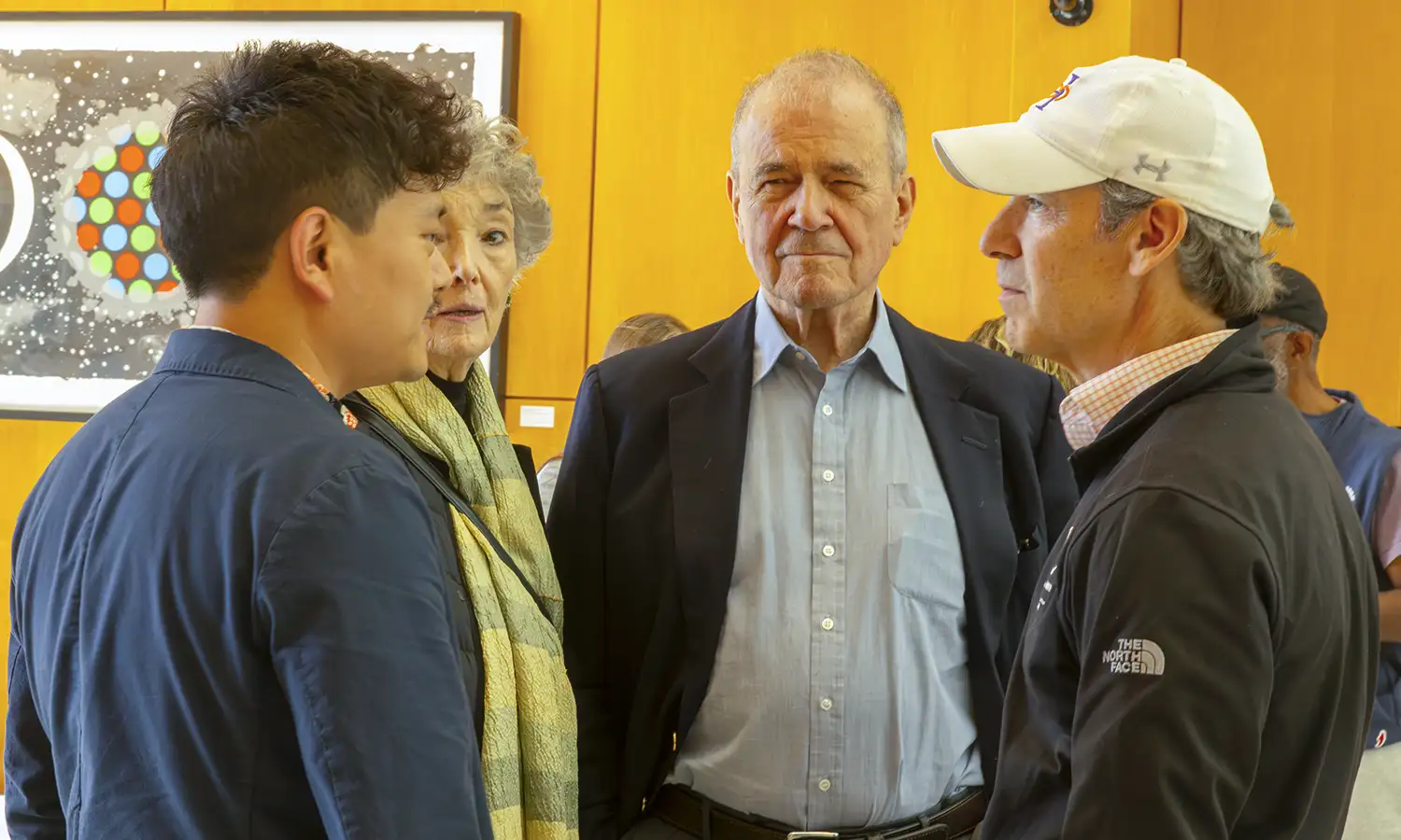 Award-winning filmmaker Robert E. Frye ’64 (center) converses with Associate Professor of Media and Society Harry Gu (left) and Vice President for Advancement Jared Weeden '91 (right) during the Media and Society Program’s 30th Anniversary celebration.  