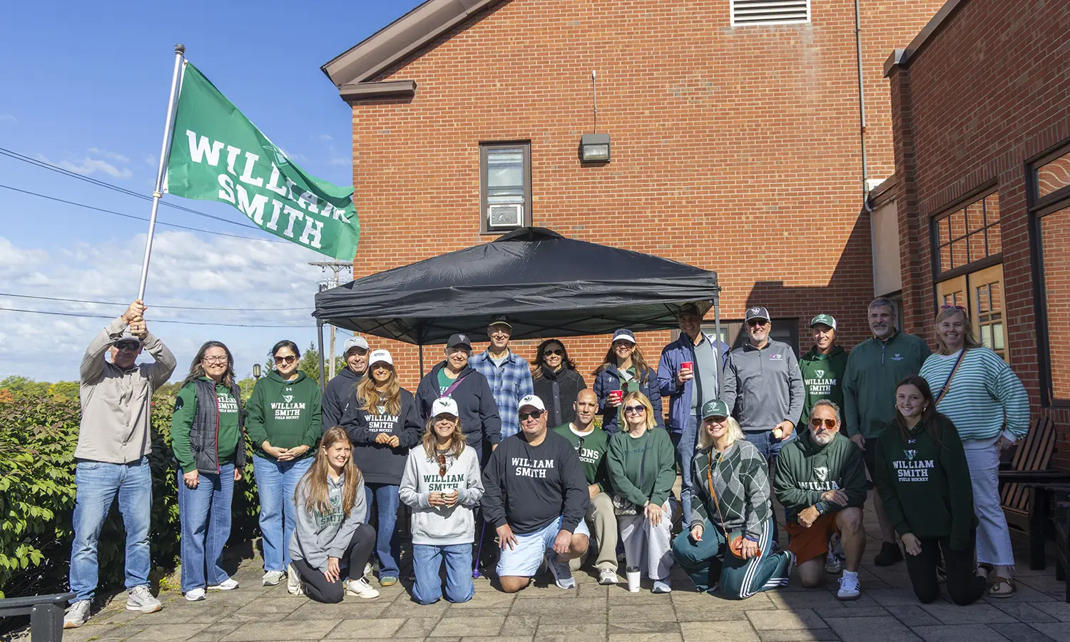 William Smith field hockey fans gather for a group photo before the Herons took on Vassar at McCooey Field. 