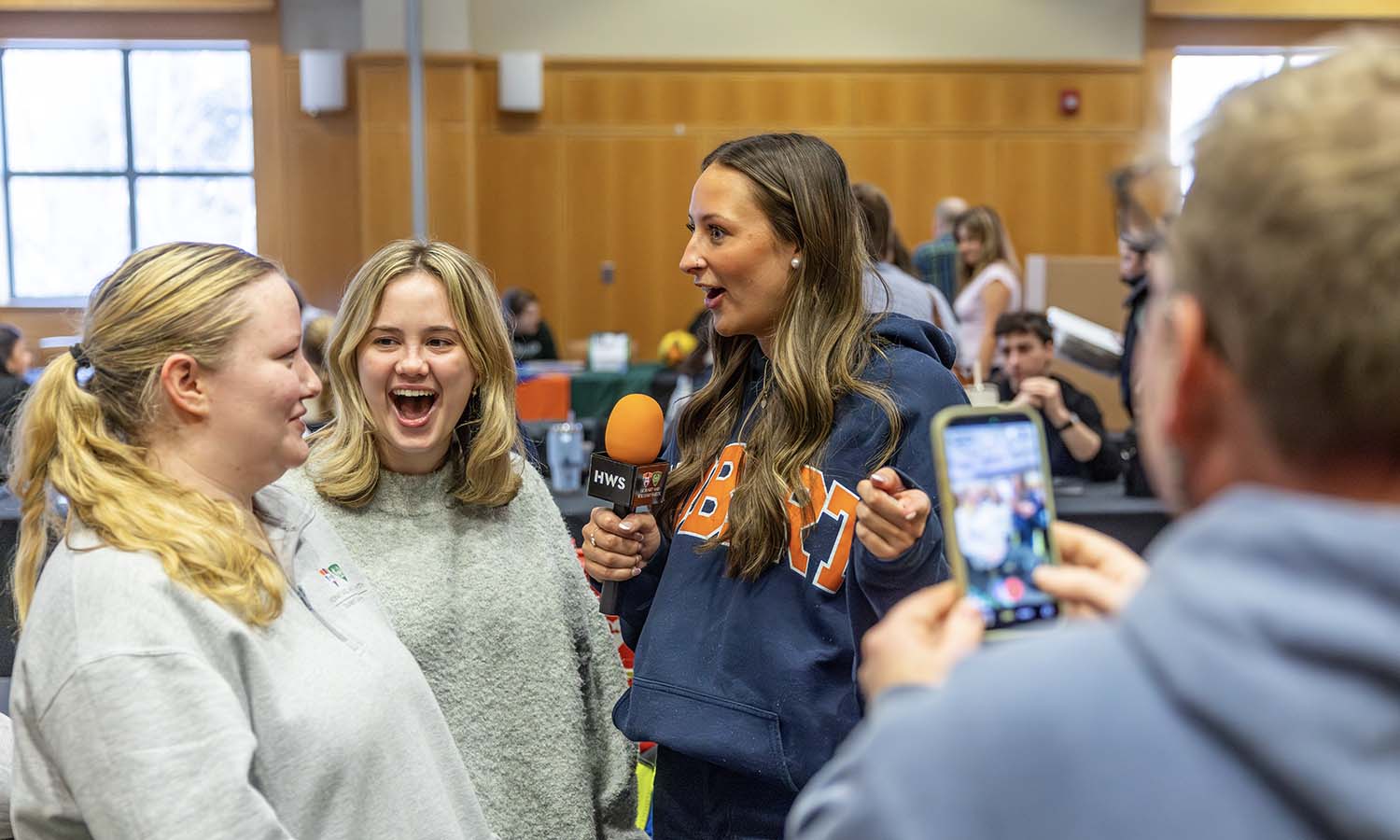 At the Involvement Expo, Emily Gorczynski ’26 and Kaleigh McPhail ‘28 are interviewed by Malya Sayre ’26 for a @hwscolleges social media video.  