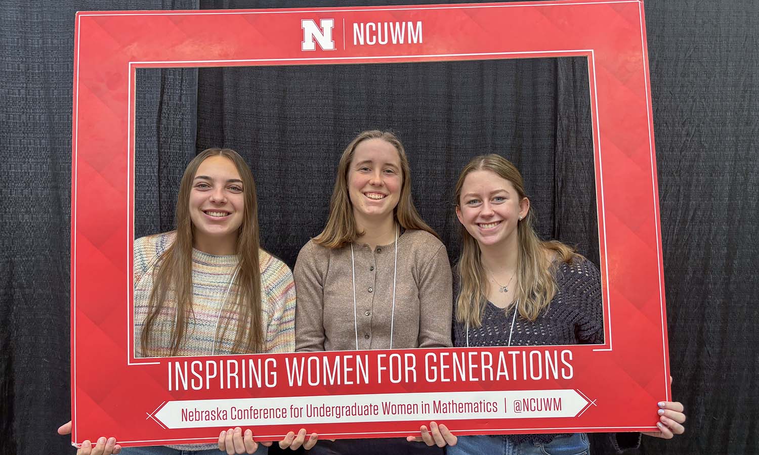 Sarah Shoobe '28, Ruth Hotaling '26 and Madelyn Krueger '26 pose for a photo at the Nebraska Conference for Undergraduate Women in Mathematics. 