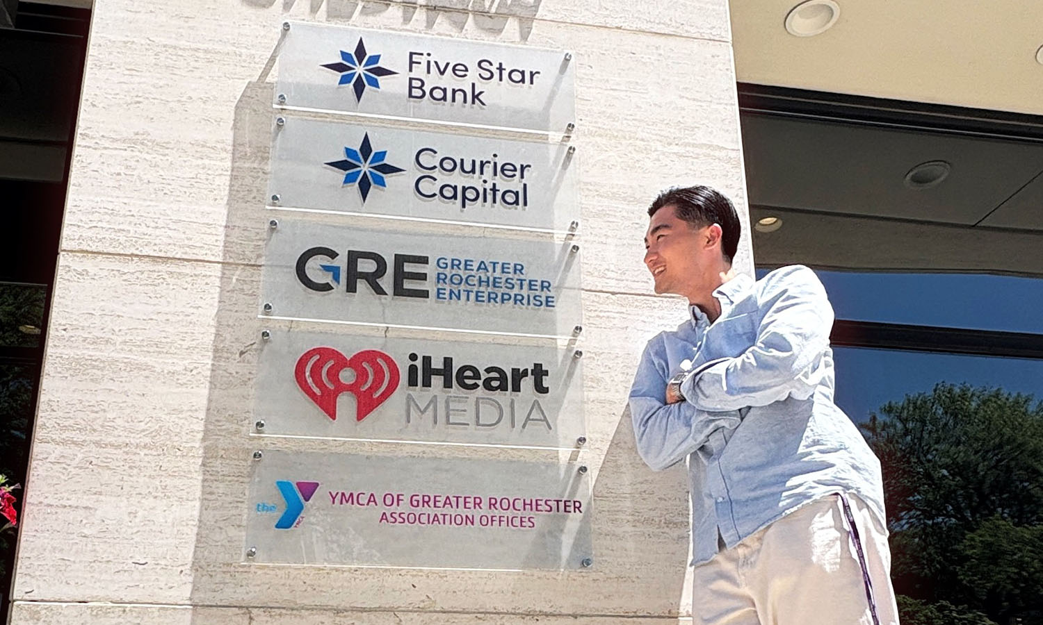 Andy Dinh '27 poses for a photo during his internship as a Data Analyst at Greater Rochester Enterprise, an economic development organization that supports business growth across the Greater Rochester, New York region. Andy is working with David Grome ’07, Senior Managing Director of Business Development at GRE. 
