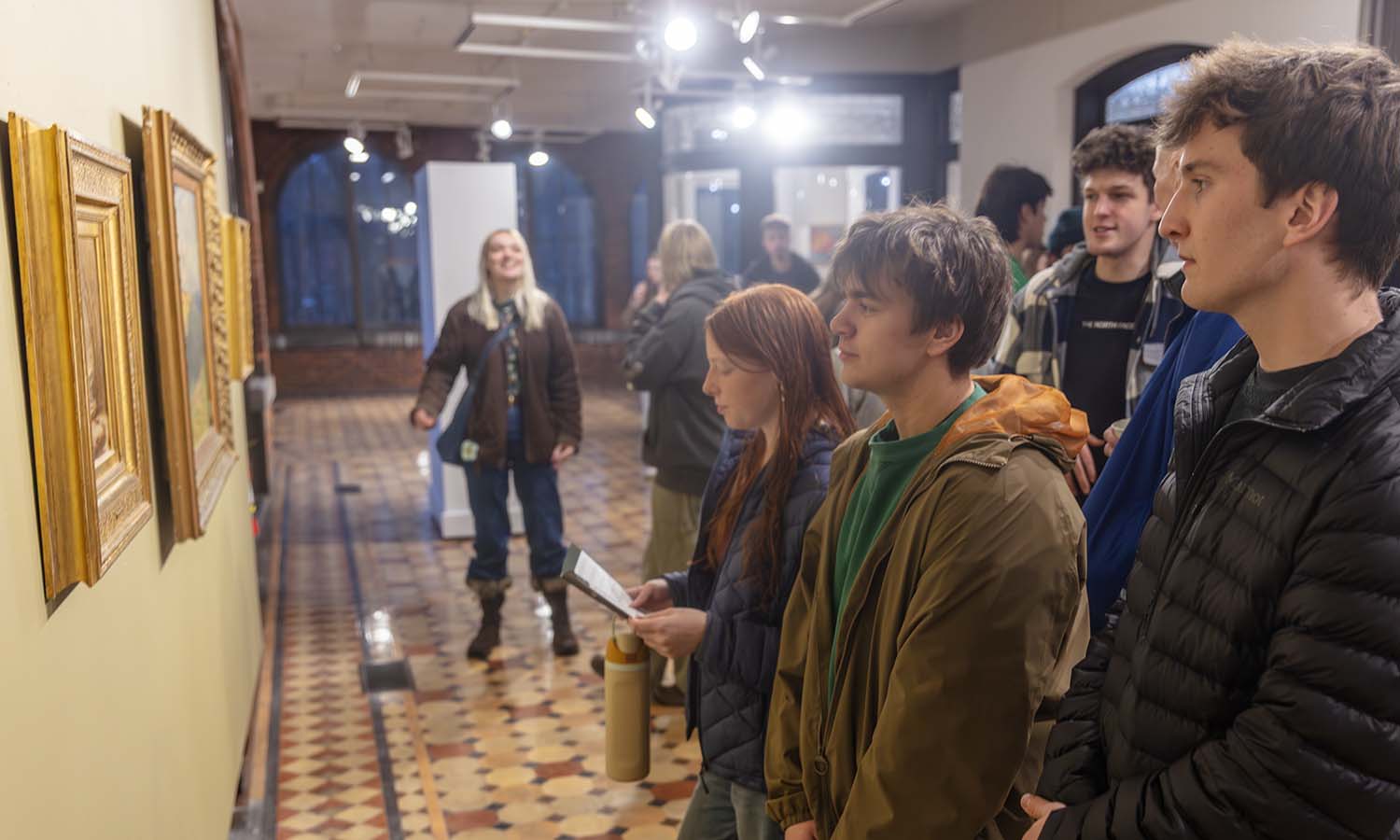 Students attend the opening reception of "Art of the Frame: Ornament and Meaning" at Davis Gallery in Houghton House. 