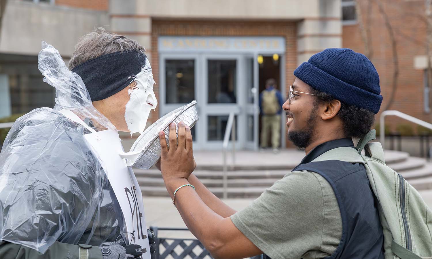 Daudi Aden ’26 pies Associate Professor of Mathematics and Computer Science Chris Fietkiewicz in celebration of Pi Day. 
