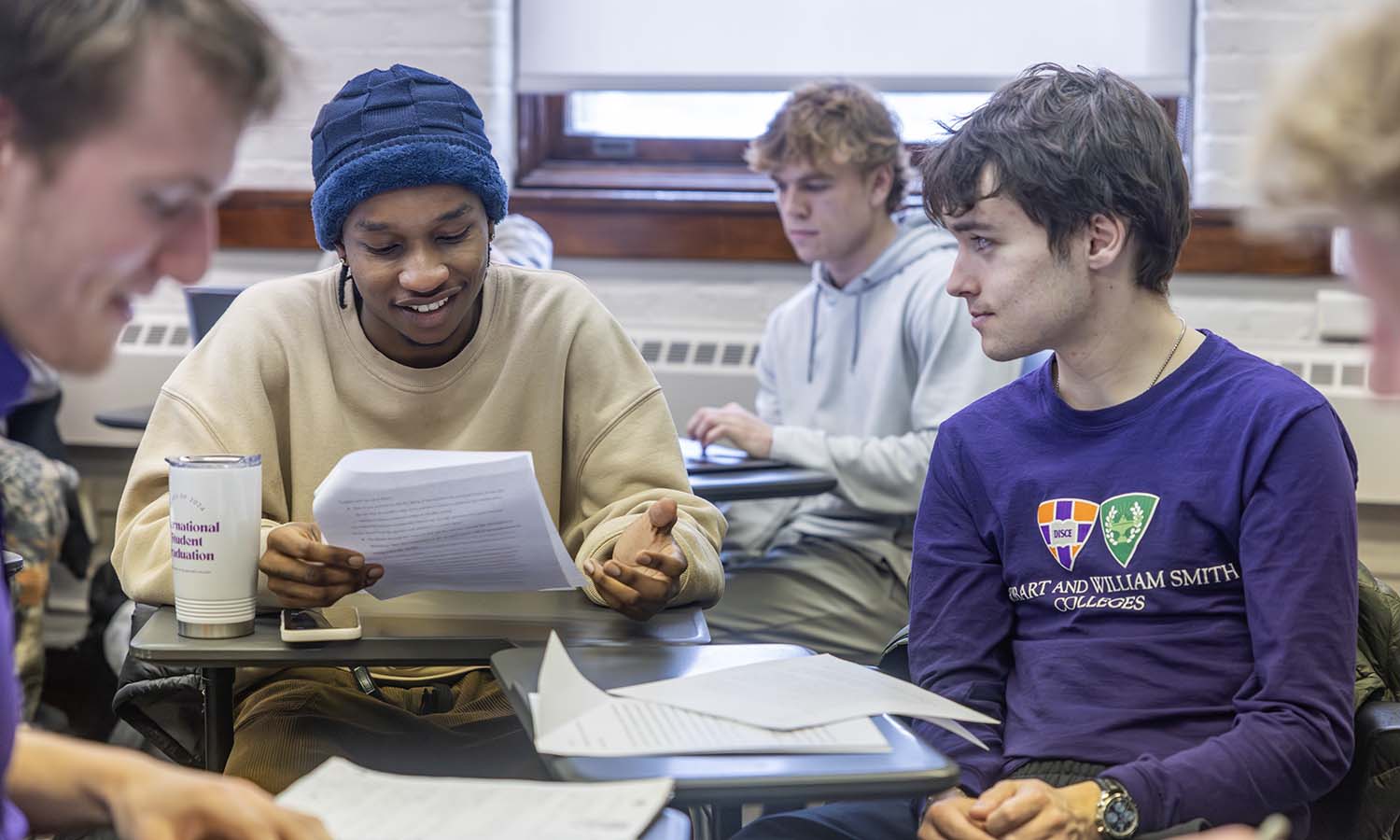Sean Mucheru ’26 and Nathaniel Pollard ’29 prepare for an in-class debate during “It Belongs in a Museum!” with Visiting Assistant Professor of Anthropology Brian Clark. 