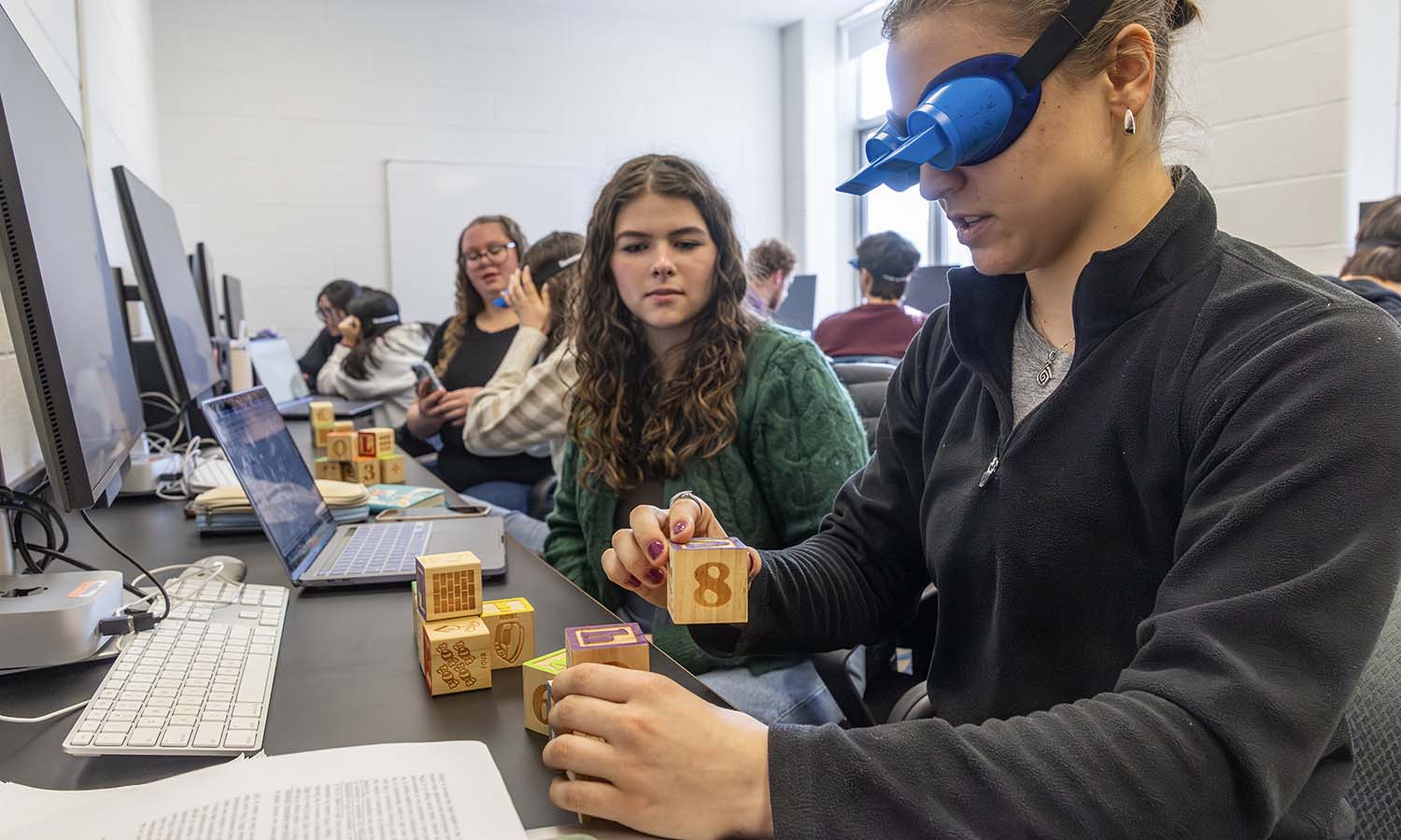 During Professor of Psychological Science Daniel Graham’s “Capstone on Perception,” Elena Roll ‘27 and Ella Raiti ’26 perform a series of tasks using inversion goggles. 