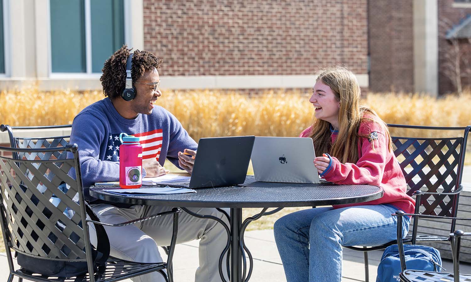 Nicholas Short ’27 and Lily Keefe ’27 take advantage of the warmer weather to study outside.