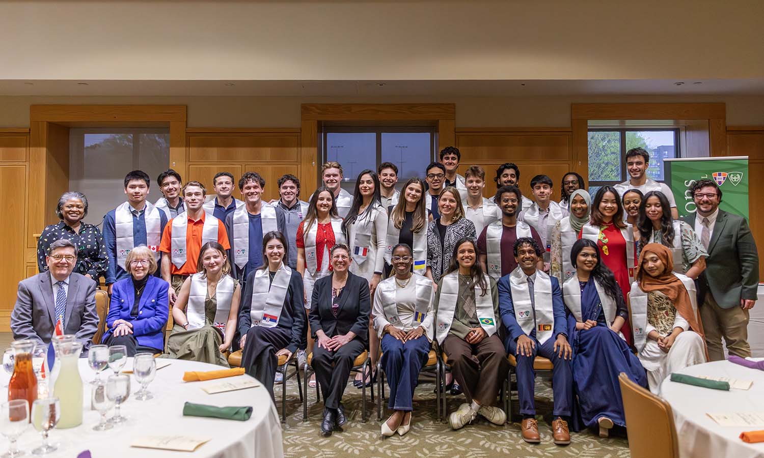 President Mark D. Gearan and Mary Herlihy Gearan join staff and international students for a group photo following the International Student Celebration. 