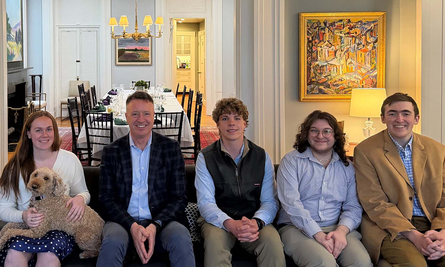 In the President’s House, Maggie Woodruff ’26, former Trustee William Green ’83, Henry Bindig ’28, Alex McLaughlin ’27 and Johnny Bewley ’27 pose for a photo following a dinner to celebrate the Green Scholars. 