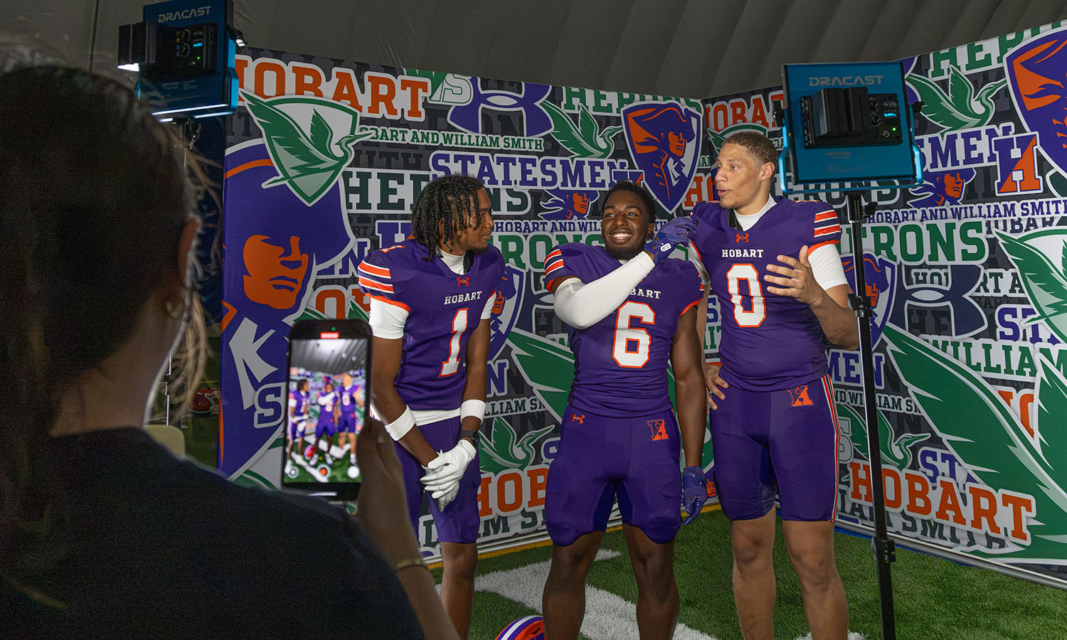 Auben Ball '27 records a social media promo with Isa Abdus-Salaam '29, Juah-Siblay Kolliegbo '29 and Tru Styles '27  during Hobart Football's media day. 