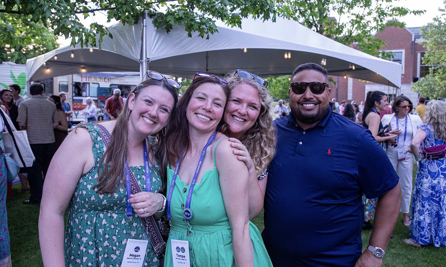 On the Café Patio, alums pose for a photo during the Friday Night Food Trucks. 
