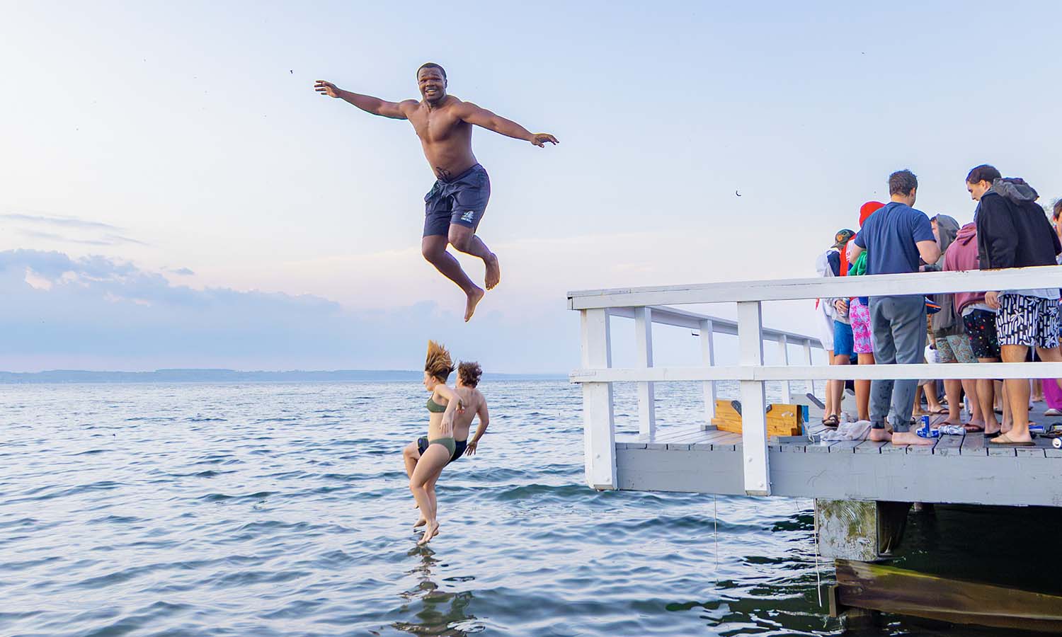 Byron Maddox ‘26 jumps off the railing of Bozzuto Boathouse on the Sunday morning of Commencement. 