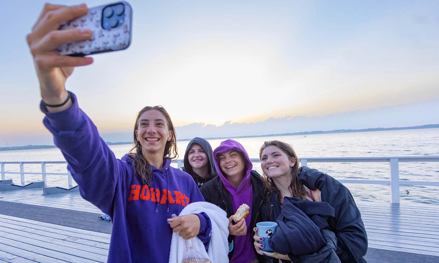 Members of the William Smith rowing team take a selfie after sunrise. 