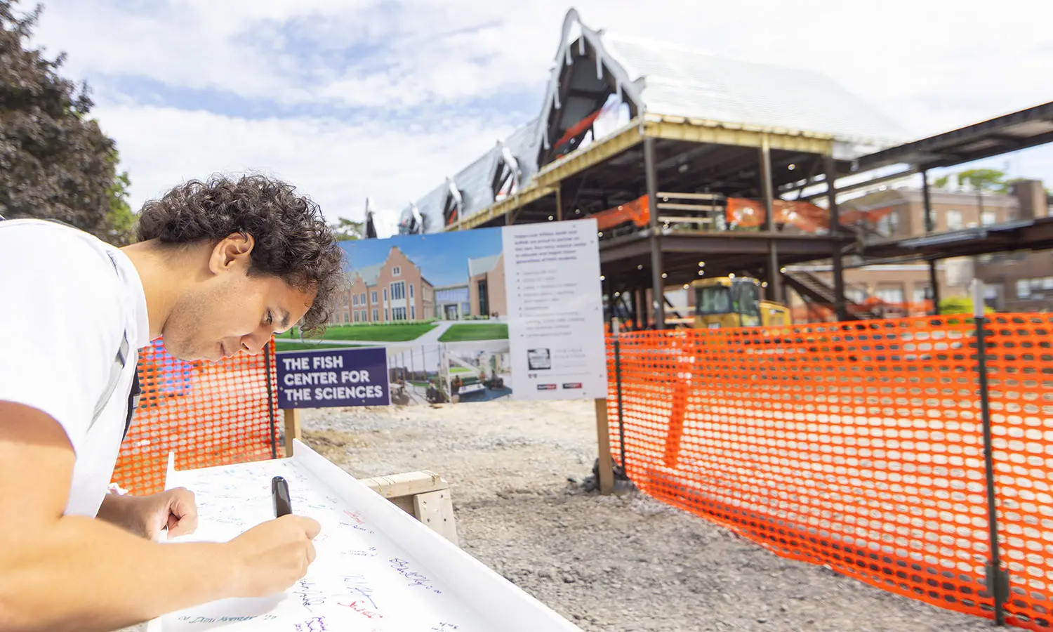Arden Jalal '30 was one of dozens of students, faculty and staff who signed the final beam to be placed in the Fish Center for the Sciences. 