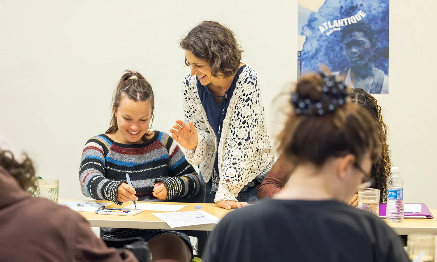 Professor of American Studies Kirin Makker provides a helpful tip to Reilly Roedel '27 while working on a color chart in "Drawing for Study and Storytelling." 