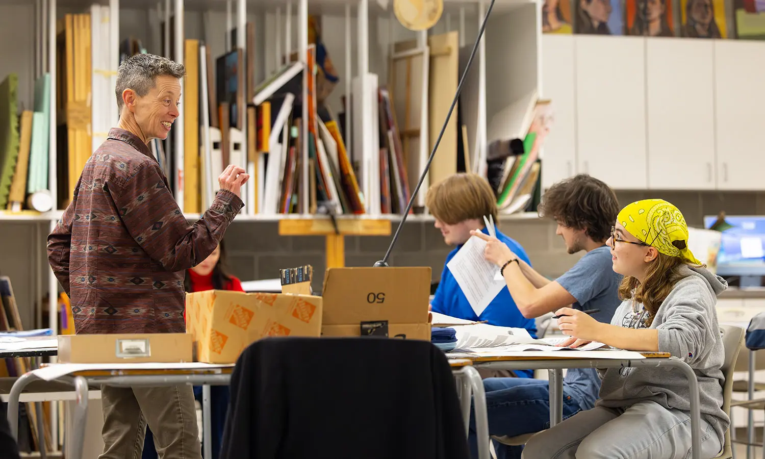 Professor of Theatre H. May talks with students about their personal "manifestos" during the Theatre Senior Capstone. 