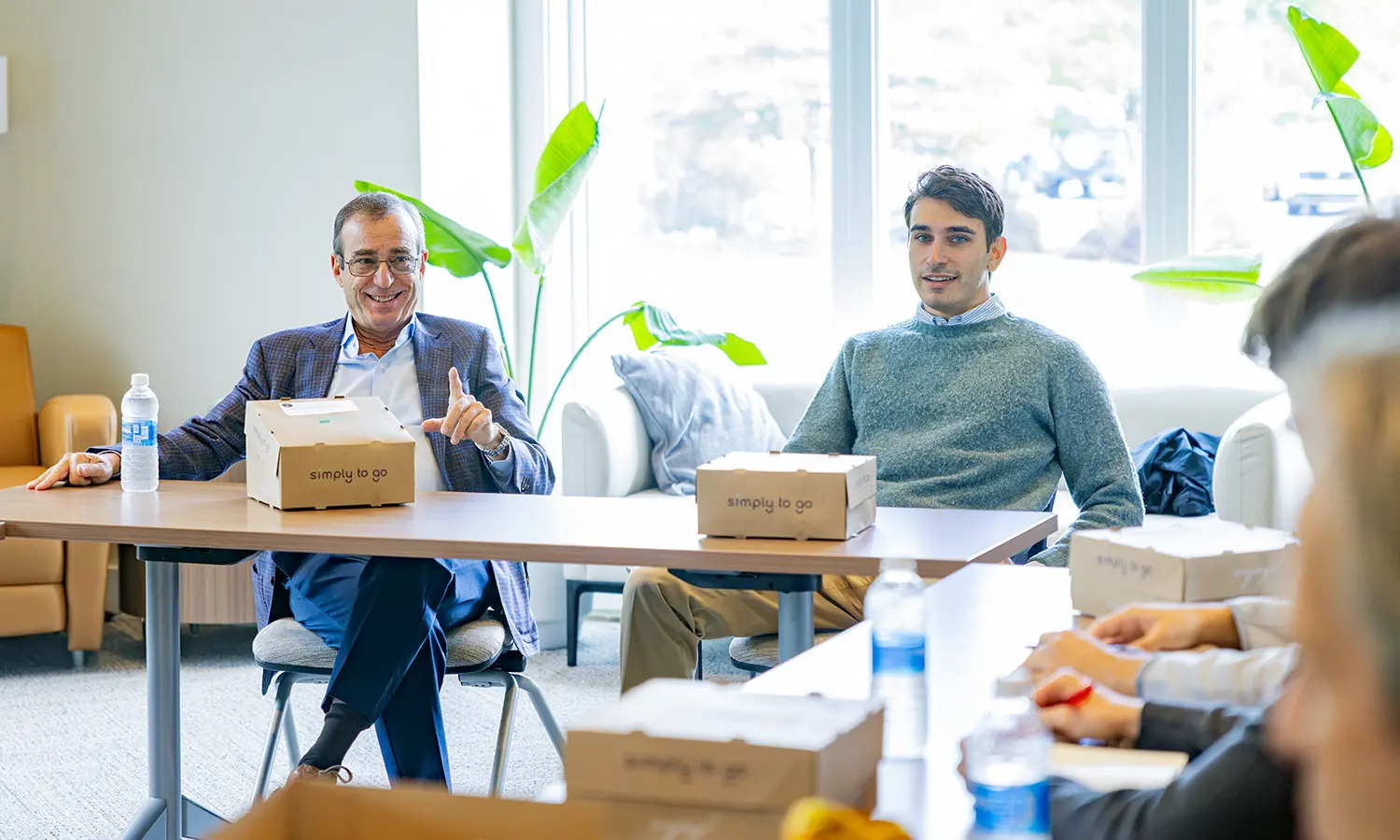 Merrill Senior Vice President, Senior Financial Advisor Peter Grayson P'18 and Consultant Bradley Grayson '18 speak with students about their careers in finance during a lunchtime discussion in the Stine Room in the Adams Intercultural Center. 