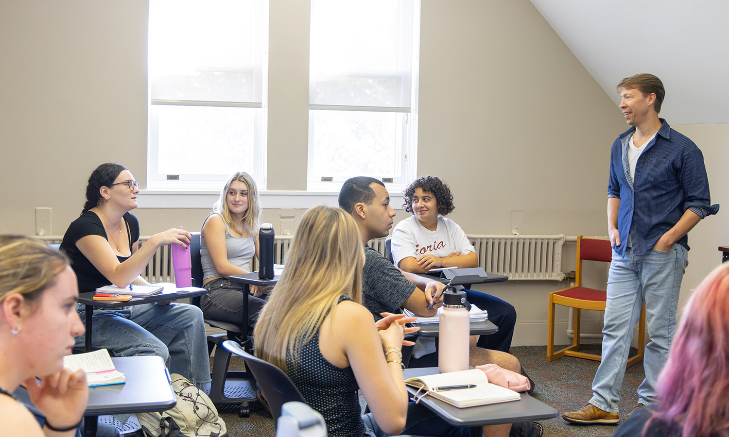 Associate Professor of Writing and Rhetoric Ben Ristow discusses game recaps with students during his "Sports Media Seminar." 