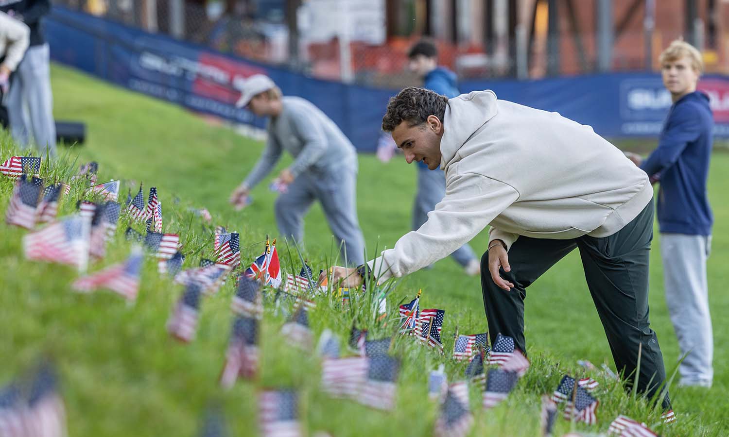Colton Lestorti ’27 of the Kappa Alpha Fraternity places flags on the Quad in remembrance of the lives lost during the attacks on Sept. 11, 2001. 