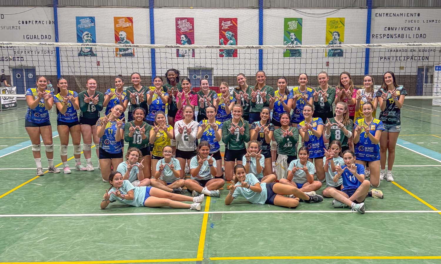 In Fuentes, Spain, the Herons and members of club voleibol Fuentes pose for a combined team photo after the two sides battled in a friendly match. 