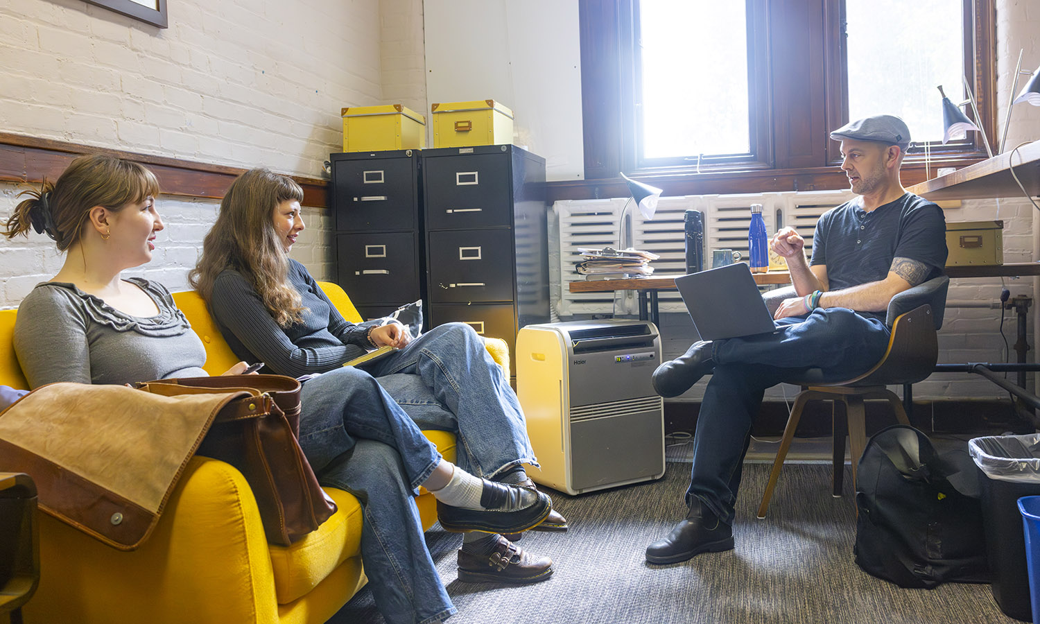 Summer Scholarship Fellows Hazel Brown ’28 and Maya Gunsberg '28 work on the Seneca Review with Associate Professor of Writing and Rhetoric and English and Creative Writing Geoffrey Babbitt. 