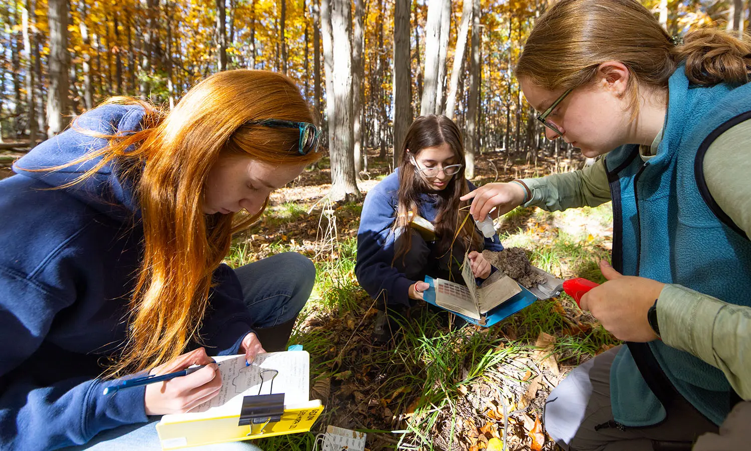 Demi Mouillesseaux ’28, Angela Ciccone ’28 and Elizabeth Molisaniin ’28 analyze sediment from former floodplains to build hypotheses linking climate change to historic stream incision in Cooper's’ Woods during 