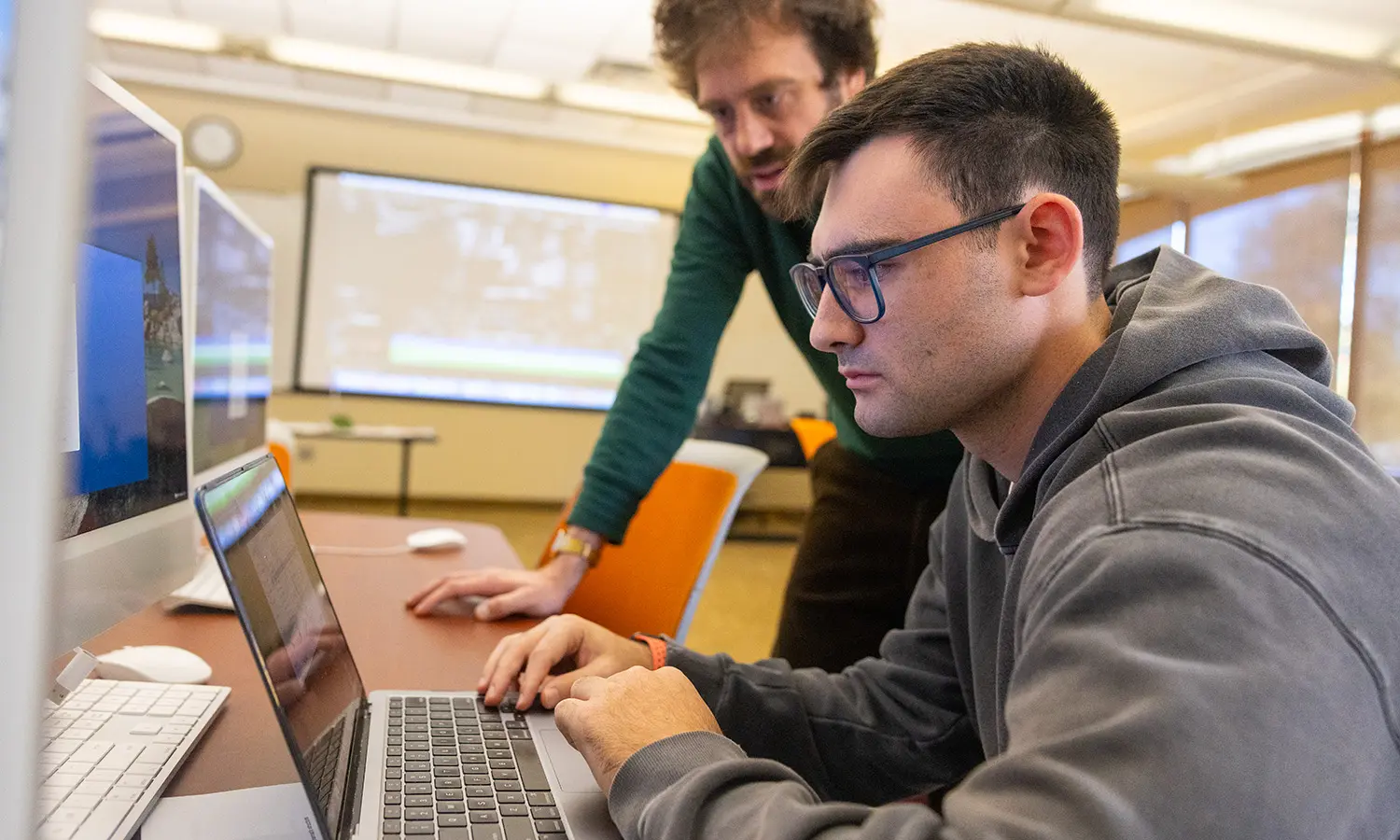 Professor of Practice, in Media and Society Casey Puccini assists Hugo Maggio '27 during "Film Editing."  