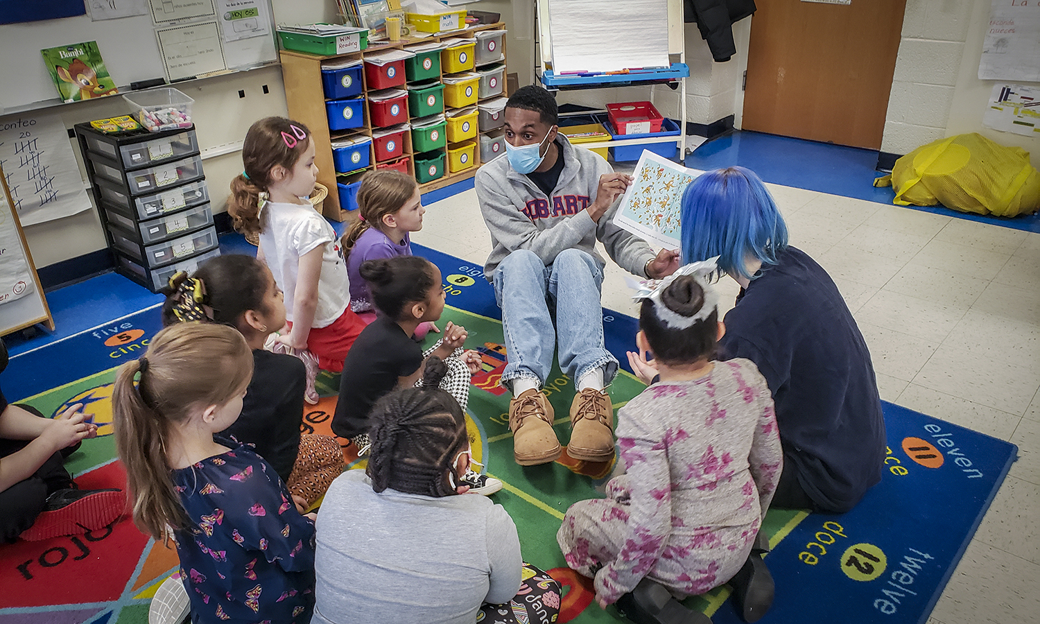 Student reads a Spanish children's book to local children.